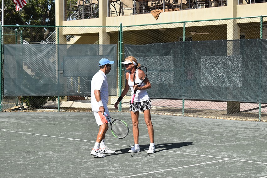 Marc Jarman and Brenda Terihay converse over a point.