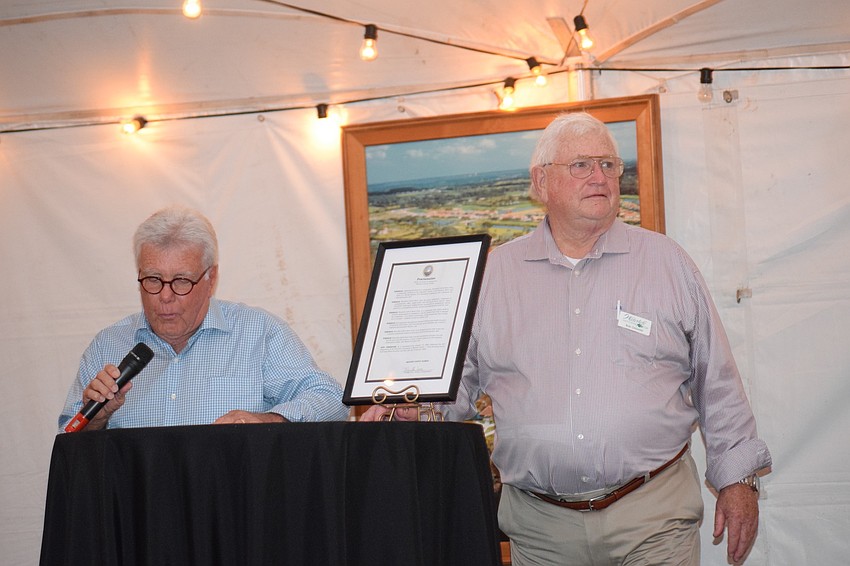 Ken Bumgarner, CDD chairman, and Bob Griswold, president of the Homeowners Association, share comments during the celebration of Waterlefe Golf and River Club's 20th anniversary.