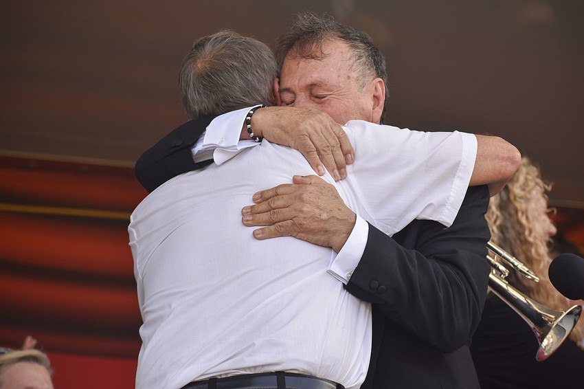 Keith Green and Pedro Carrillos, Sr. embrace.