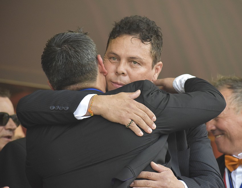 Pedro Carillo and Luis Acosta embrace.