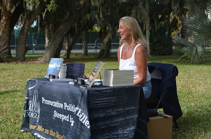 Sally Fernandez speaks at a book signing Sunday on the lawn of Longboat Library.