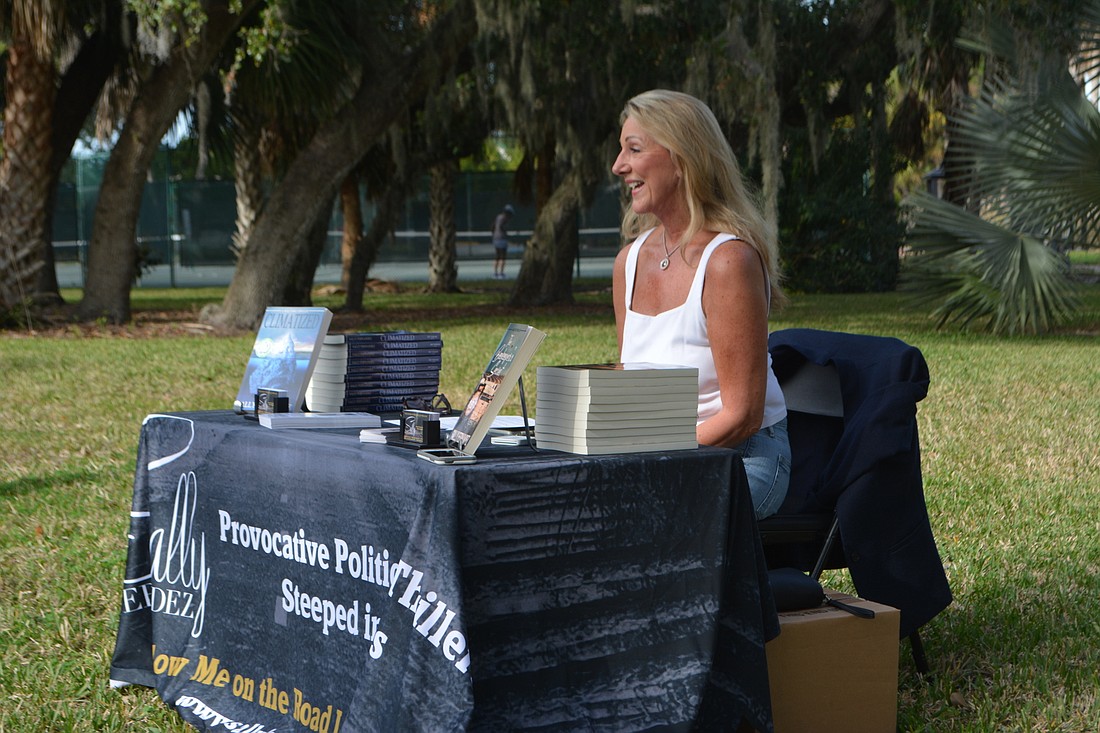 Sally Fernandez speaks at a book signing Sunday on the lawn of Longboat Library.