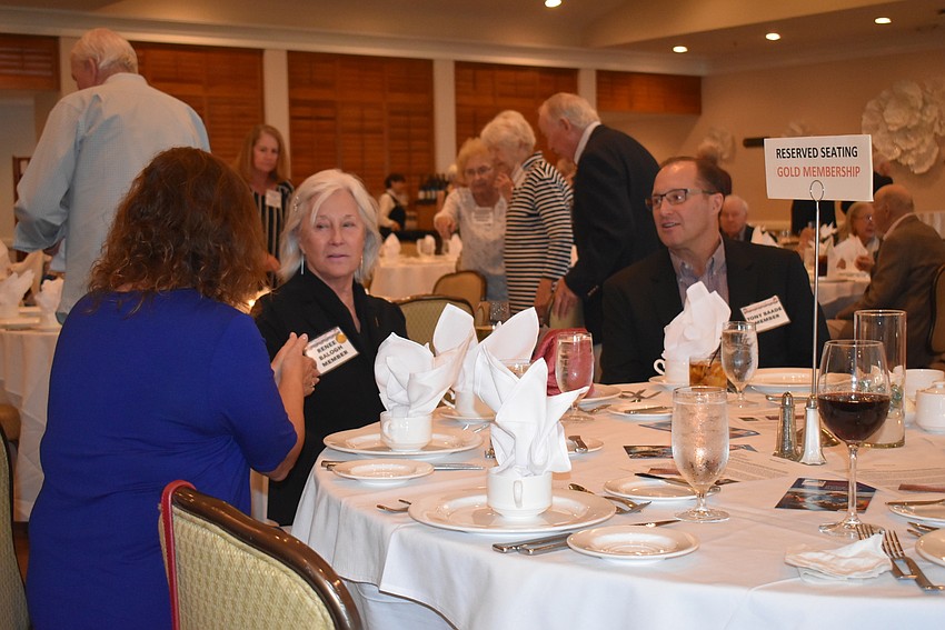 Members mingle before dinner begins.