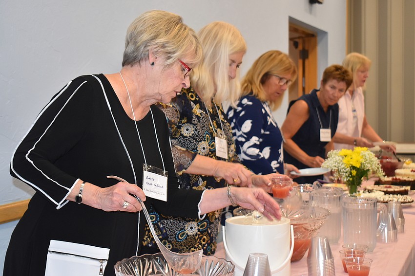 The women lined up for refreshments before the meeting began.