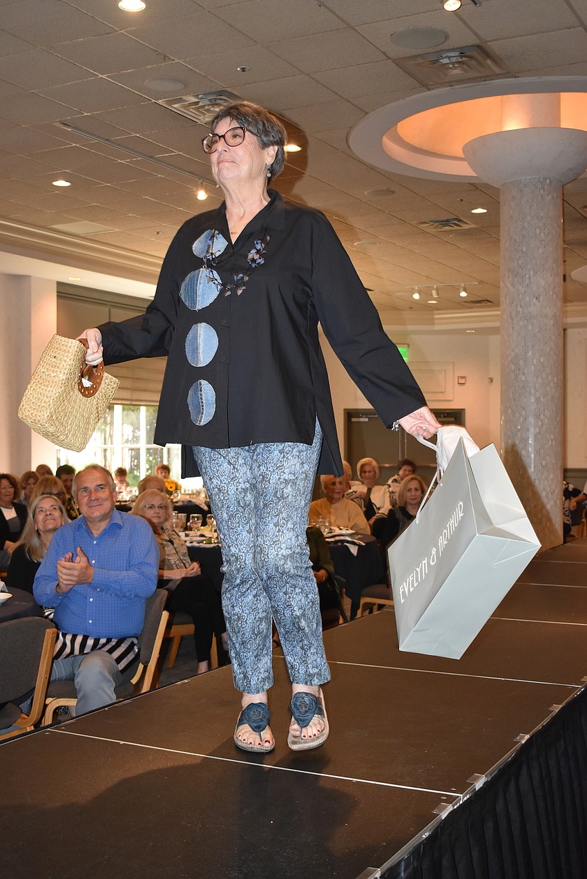 Debbie Cohen carries an Evelyn and Arthur bag down the runway.
