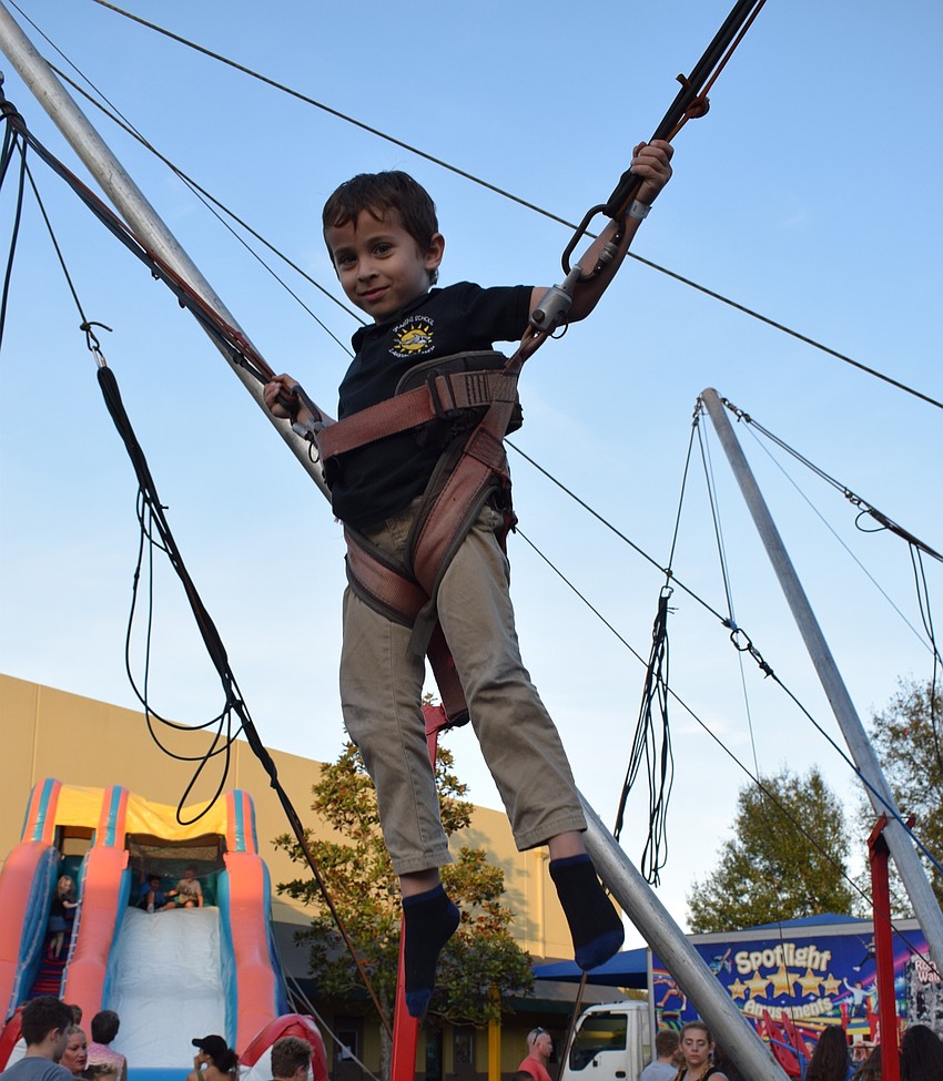 Mason Collier, a kindergartner, jumps as high as he can on the bungee trampoline.