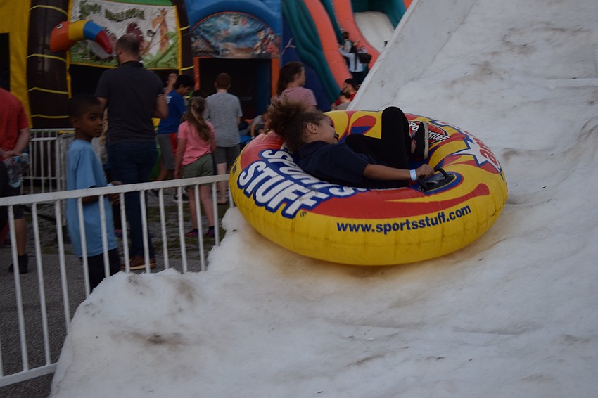 Ariela Rosario, a kindergartner, speeds down a snow slide before rejoining her siblings 3-year-old Athalia and second grader Urijah.