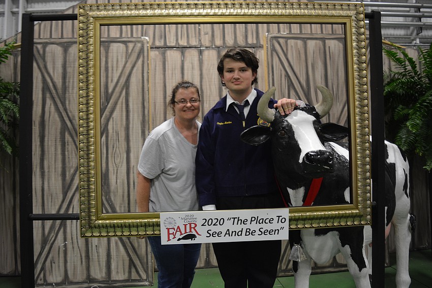 Michelle Bowman-Edwards and her son, Liam Edwards, check out the craft exhibits after learning Liam Edwards won best of show for plants.