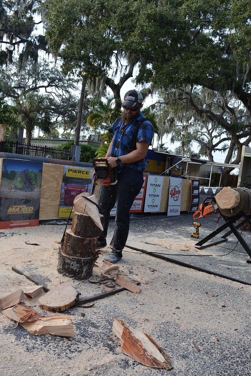 Lyle LeCaptain uses a saw to shape the top of a tree during Paul Bunyan's Lumberjack Show.