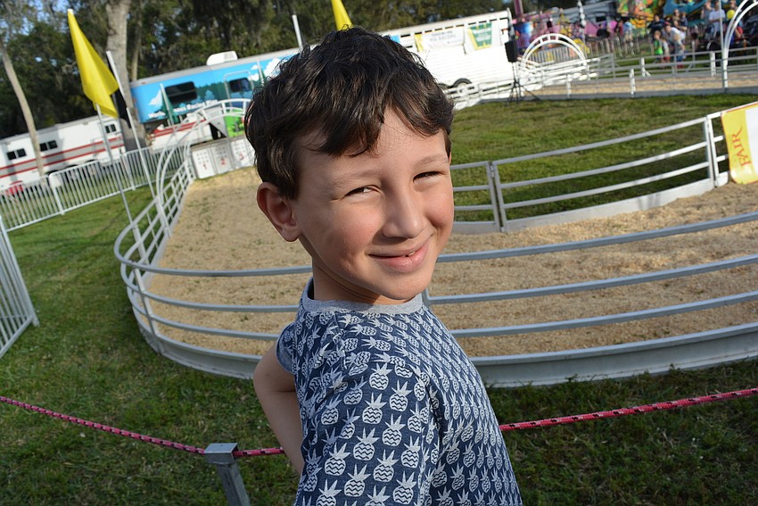 Six-year-old Forrest Mitchell, who was visiting from Orlando, would win a prize if Pig No. 4 won the pig race.
