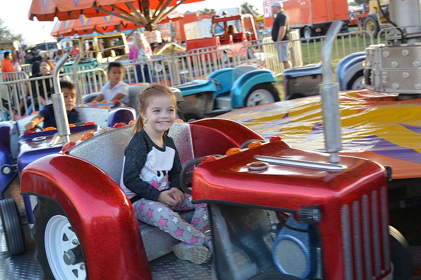 Parrish 4-year-old Zoey Jeffers has ridden on a tractor at home, but she liked the one she rode at the fair, too.