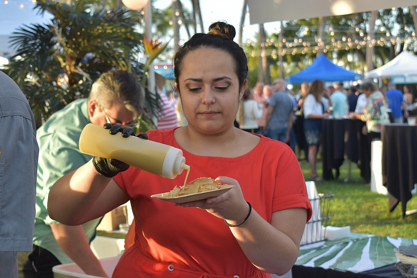 Chelsea Sandoval prepares a plate of grouper.