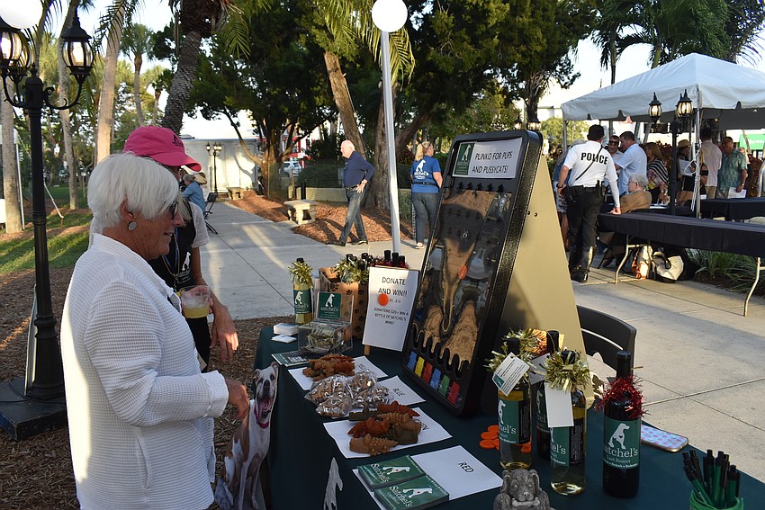 Anne Andorn waits to see what she won from Satchel's while Page Knoebel watches.