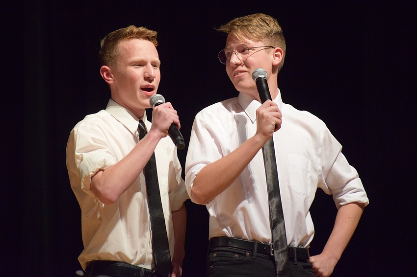 After riding onto the stage on bikes, Logan RAnke and Hayden Ranke sing 