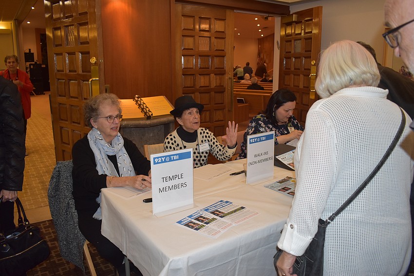 Attendees check in to the event.