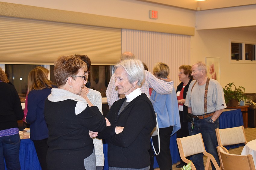 Groups of attendees socialized prior to the discussion.