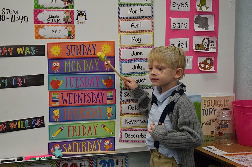 Grayson Wiehl, a kindergartner, takes his class through the days of the week while dressed as a 100-year-old man.