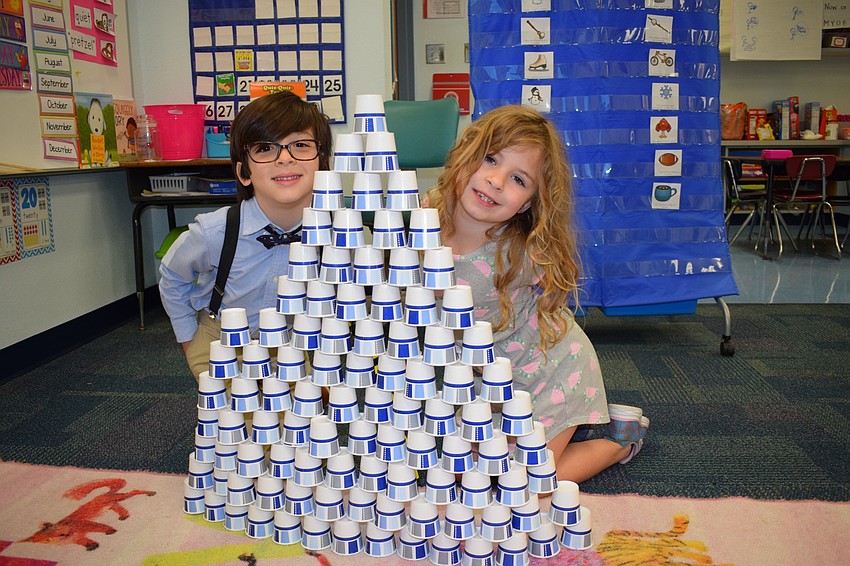 Kindergartners Samuel Vergara and Serenity Cardwell complete their tower made out of 100 paper cups. Building towers was just one activity to celebrate the 100th day of school.