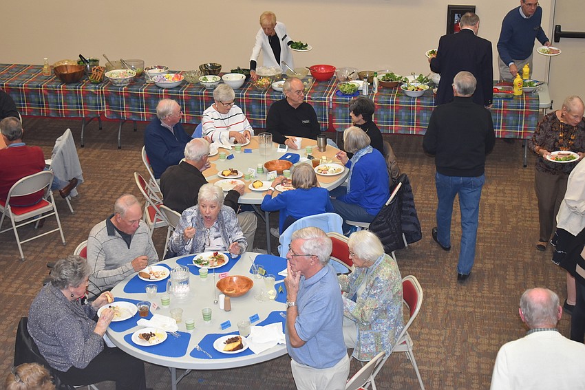 Attendees gathered at tables with friends.