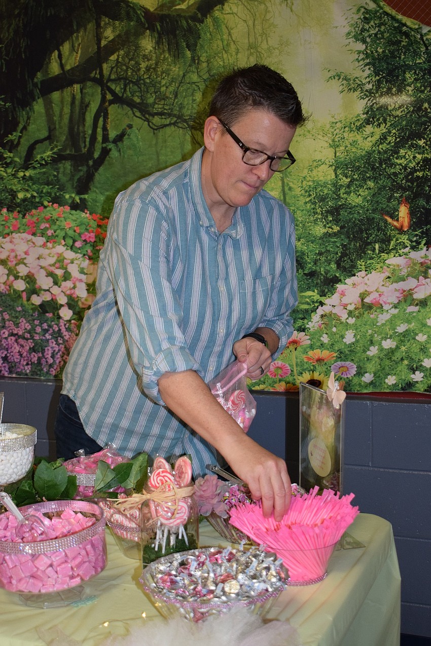 Cary Jones, a co-vice president of the Parent Teacher Organization, prepares a bag of candy from the candy buffet.