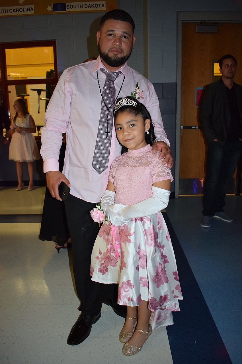 Sequiel Martinez and his daughter Jordice, a second grader, have fun at the dance. Jordice Martinez says the dance was good because she loves her dad.