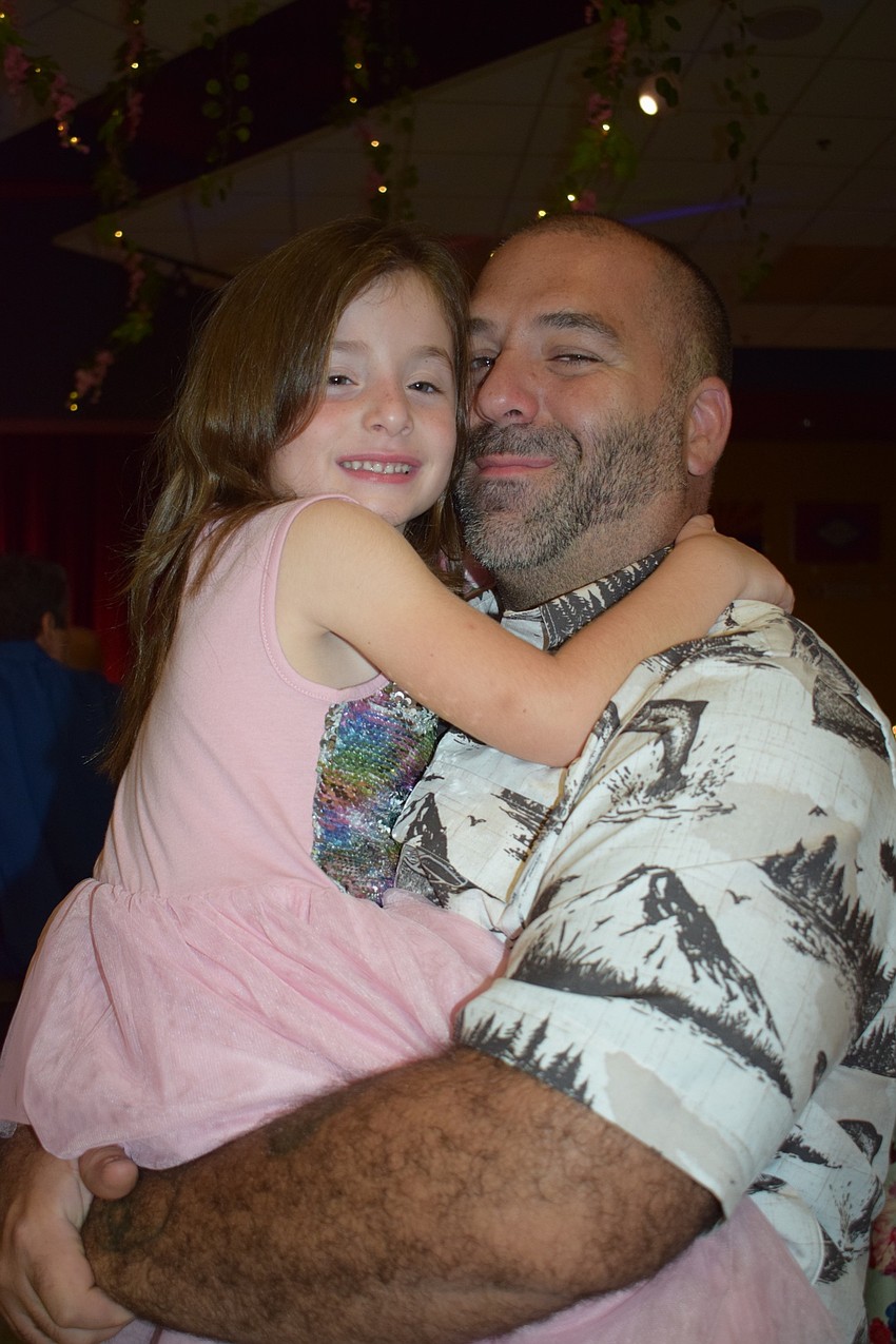 Gwen Frost, a pre-kindergartner, dances with her dad, Pete, during their first daddy-daughter dance. Pete Frost has been to the dance before with his other daughter, Autumn, who is a first grader.