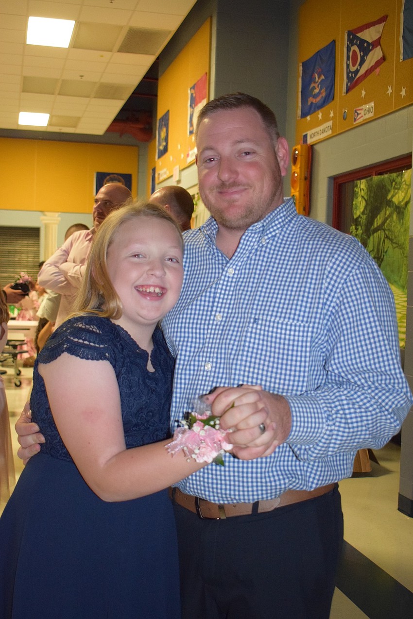 Emma VanBeck, a fifth grader, enjoys her final daddy-daughter dance with her dad, Nick.