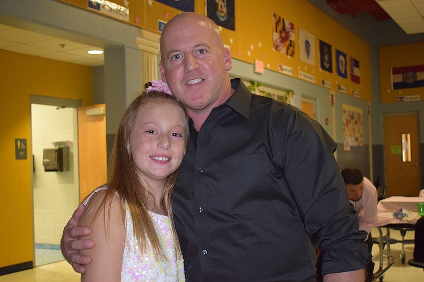 Braelynn Routh, a fourth grader, and Tim Collett have fun during the daddy-daughter dance.