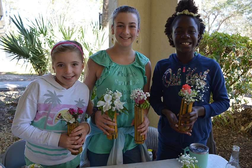 Bella Roadman, Emma Raulerson and Estella Long sold fresh flowers in bamboo vases made from bamboo in the Raulerson's back yard.