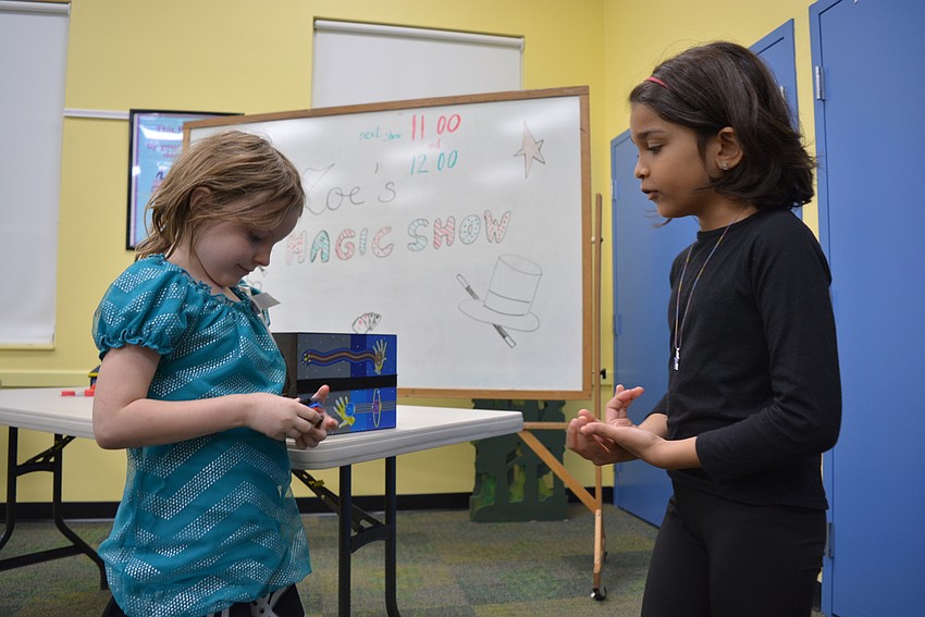 Bradenton's Emma Beardsley picks a number, which Zoe Balakrishnan, 8, has to guess. Balakrishnan, a student at Willis Elementary School, performed Zoe's Magic Show for event-goers for $1 per ticket.