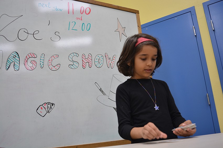 Willis Elementary School's Zoe Balakrishnan, 8, gave two magic show performances inside the library's community room. It was her first time performing tricks.