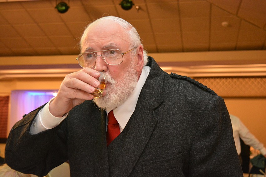 East County resident John Campbell drinks a shot of scotch after finishing the 