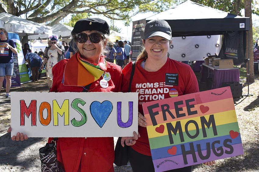 Regina Lluch and Ashley Murphy offer free hugs during the festival.