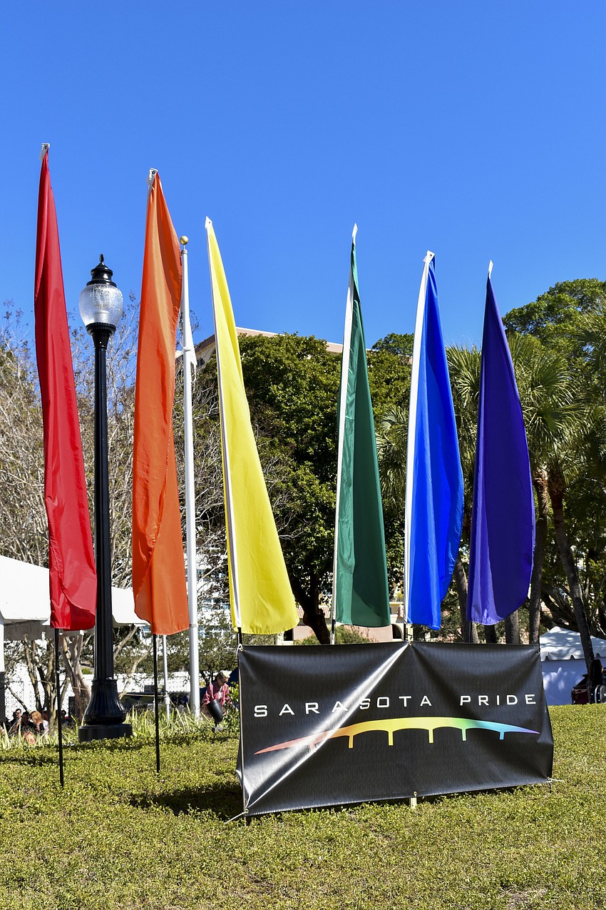 Rainbow flags wave along Bayfront Drive.