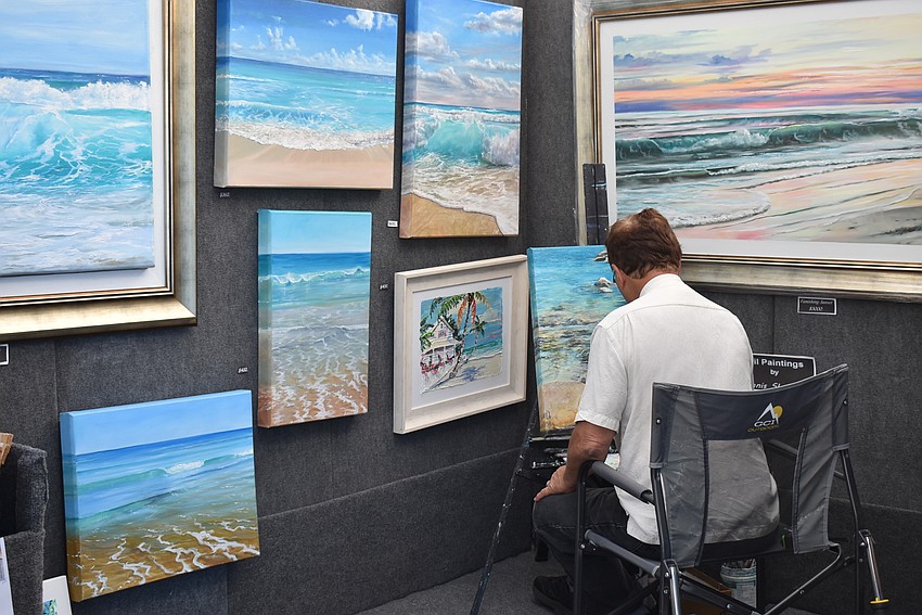 Dennis Shattuck works on another piece in his tent.