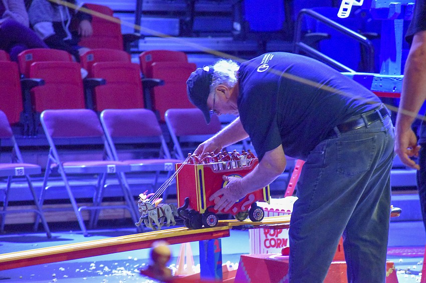 One of the circus science engineers fixes part of the machine.