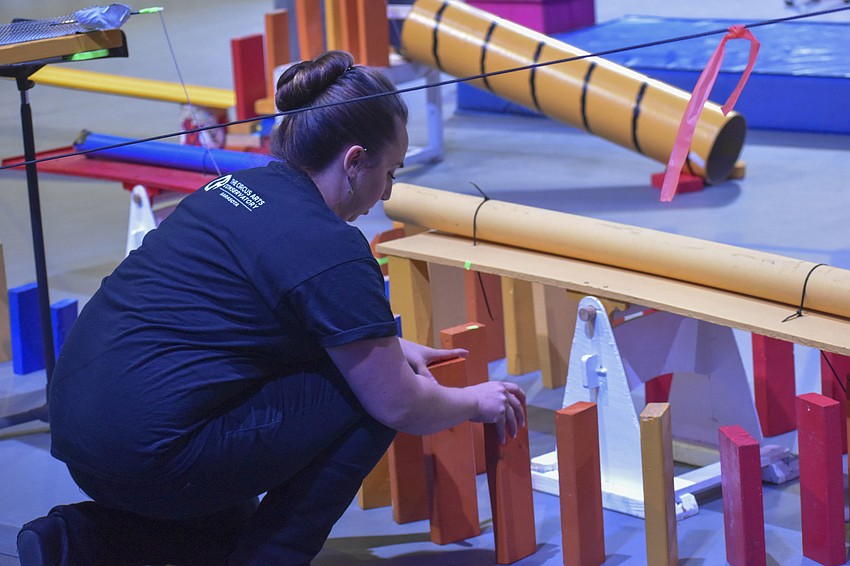 Emily Wyatt takes out the safety block from the machine.