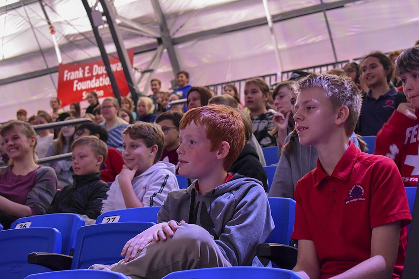 Tanner Coissman, 11, and Justice Bassiamore, 12,  watch as Zeus drops his ball into the basketball hoop.