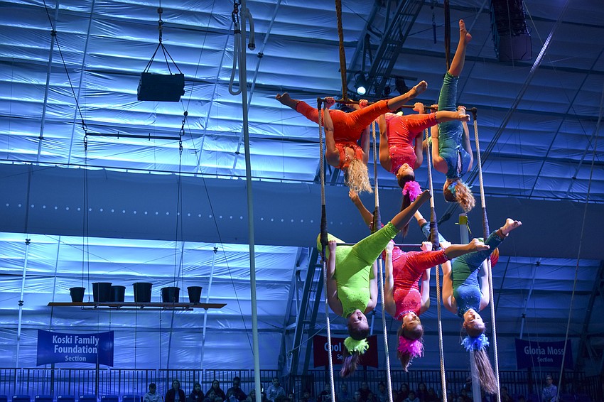 Students from the Sarasota High School circus magnet program perform on the triple trapeze.