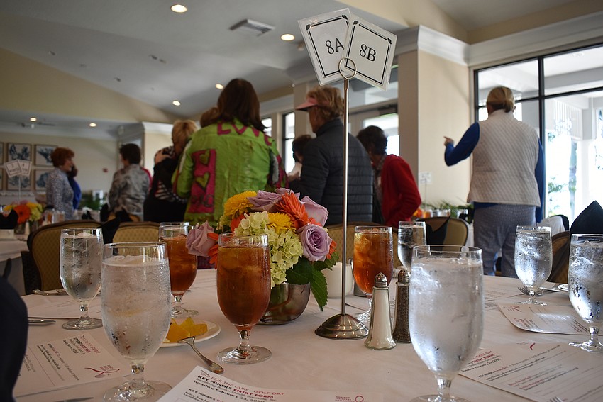 Before settling down to brunch, women chat with each other.