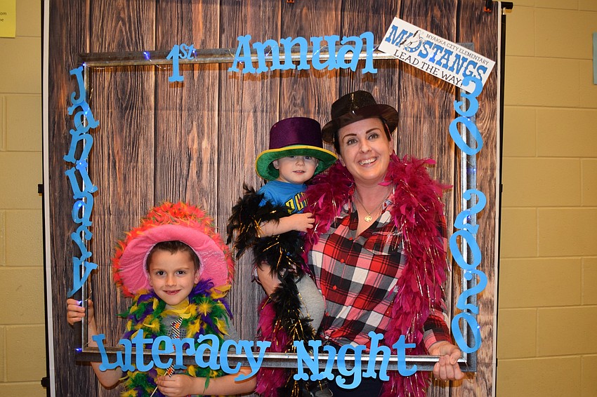 Vincent Resnick, a first grader, commemorates his first-ever literacy night with his 1-year-old brother, Archer, and his mother, Dixie.
