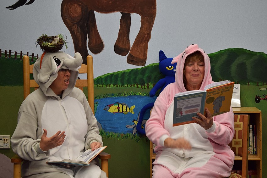 Chrstine Keen, a first grader teacher, dresses as an elephant while Karen Washington, a kindergarten teacher, dresses as a pig for their read aloud of 