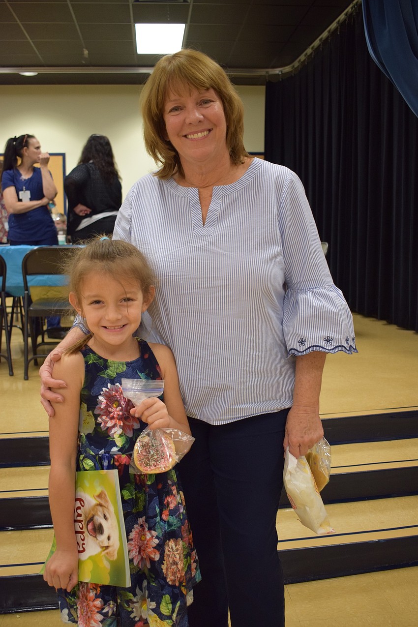 Korie Maser, a kindergartner, finishes her activities with her grandmother, Karen Washington, who is also a kindergarten teacher at the school.