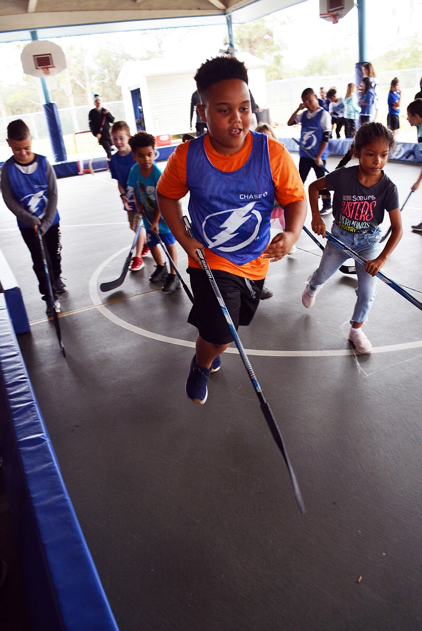 Nine-year-old Jayden Mays was ready for competition after practicing his stick-handling skills. He couldn't stop smiling as he competed in scrimmages.