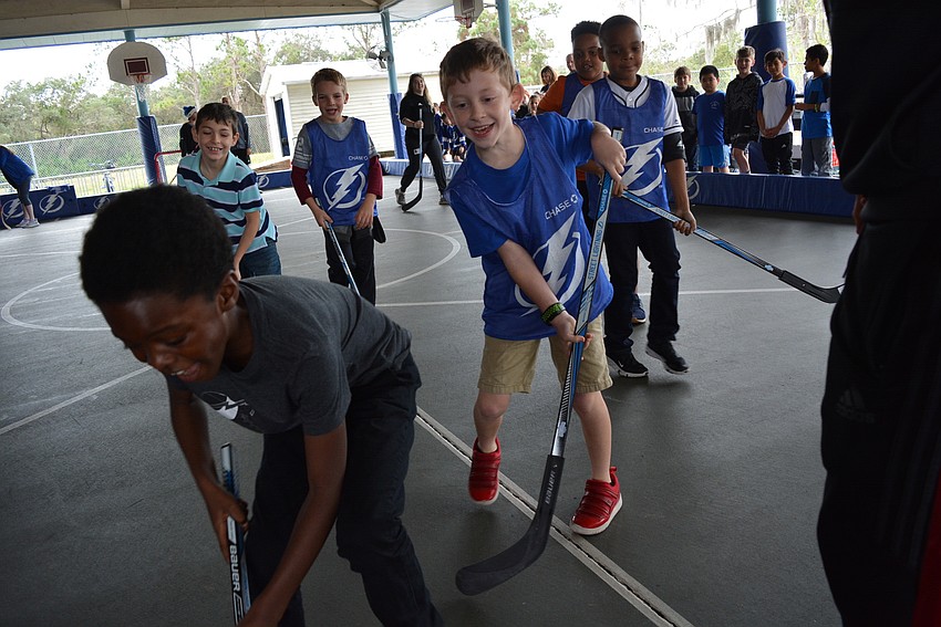 Second grader Jamoni Viverette, front left, retrieves the ball. Third grader Brody Berger, center,  is ready to snatch it away.