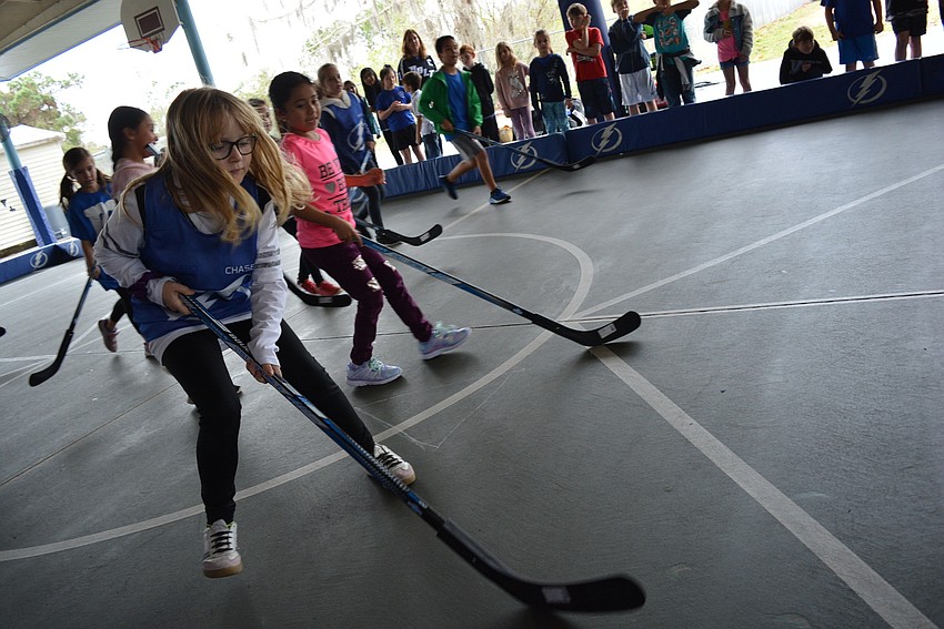 Third grader Tessa Johnson enjoys playing hockey in physical education class, but enjoyed the challenge of playing against children from other classes and grade levels.