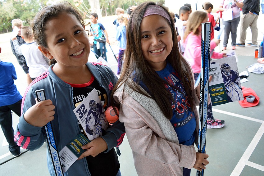 Nine-year-olds Keren Ramos and Liza Lopez love watching hockey on television. They were thrilled to get an autograph from former professional Canadian ice hockey player Mathieu Garon, who led the event.