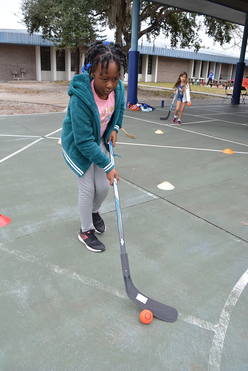 Seven-year-old Gabriella Cineus tried to keep the ball close to her stick but it rolled away more quickly than sh could catch it. 