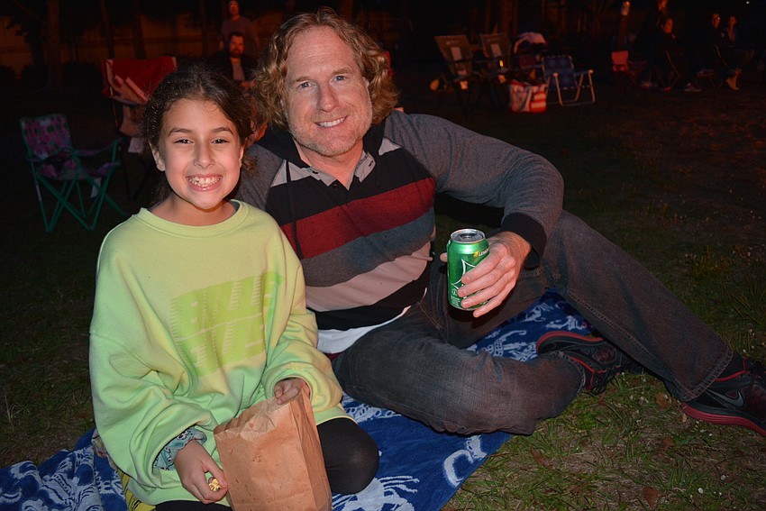 Eight-year-old Alma Miller was happy to bask in the glow from the campfire with her dad, Rob Miller, who traveled from Tampa for the event.