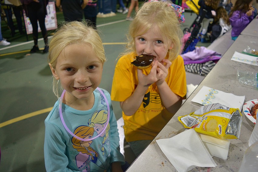 Kindergarten students Lilly Colcu and Gabriella Busenburg both feasted on chocolate covered doughnuts, which sold for $1 apiece.